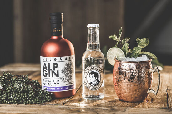 Der AlpGin Heu findet Platz neben einem Fläschchen Thomas Henry Elderflower Tonic und ein paar Holunderbeeren.